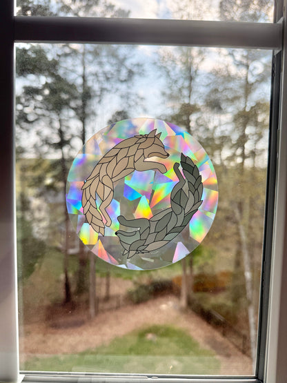 Decorative suncatcher decal with wolf design inspired by Dire Bound on a window