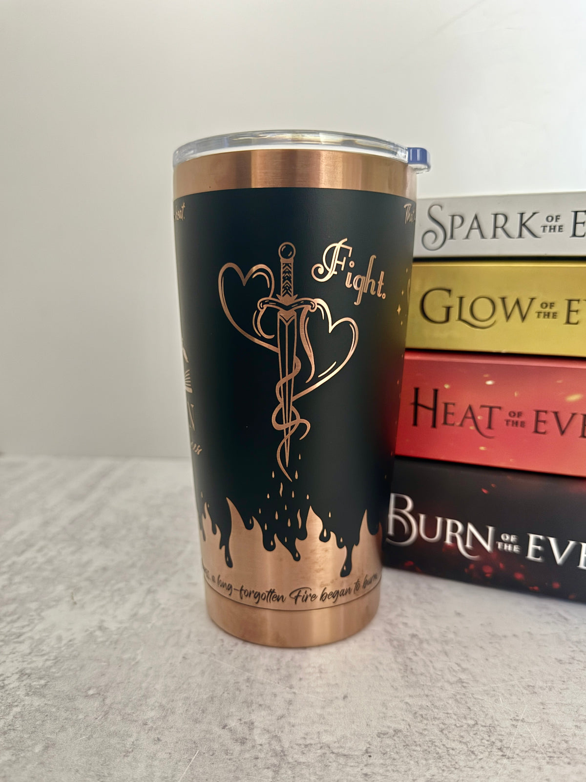 A black and copper Emarion 20 oz tumbler, showing the mating mark tattoo design and the word 'fight' from Burn of the Everflame by Penn Cole