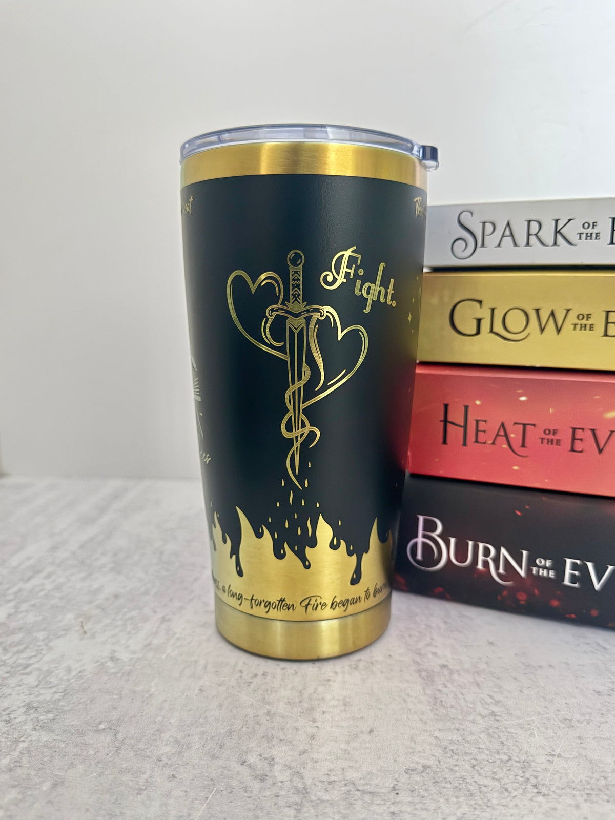 A black and copper Emarion 20 oz tumbler, showing the mating mark tattoo design and the word 'fight' from Burn of the Everflame by Penn Cole