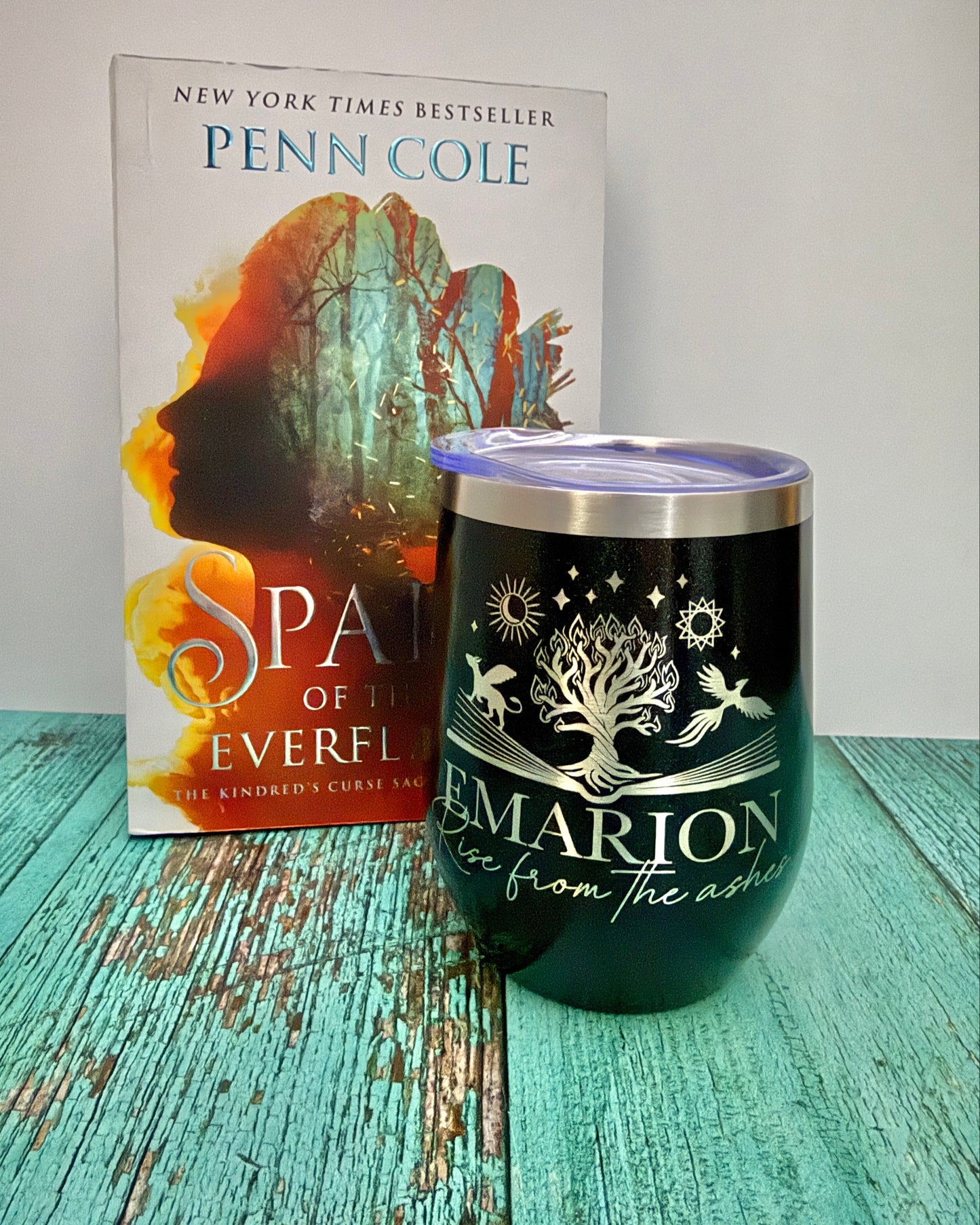 black wine tumbler with Emarion, rise from the ashes engraved on it along with the Everflame tree from The Kindred's Curse Saga