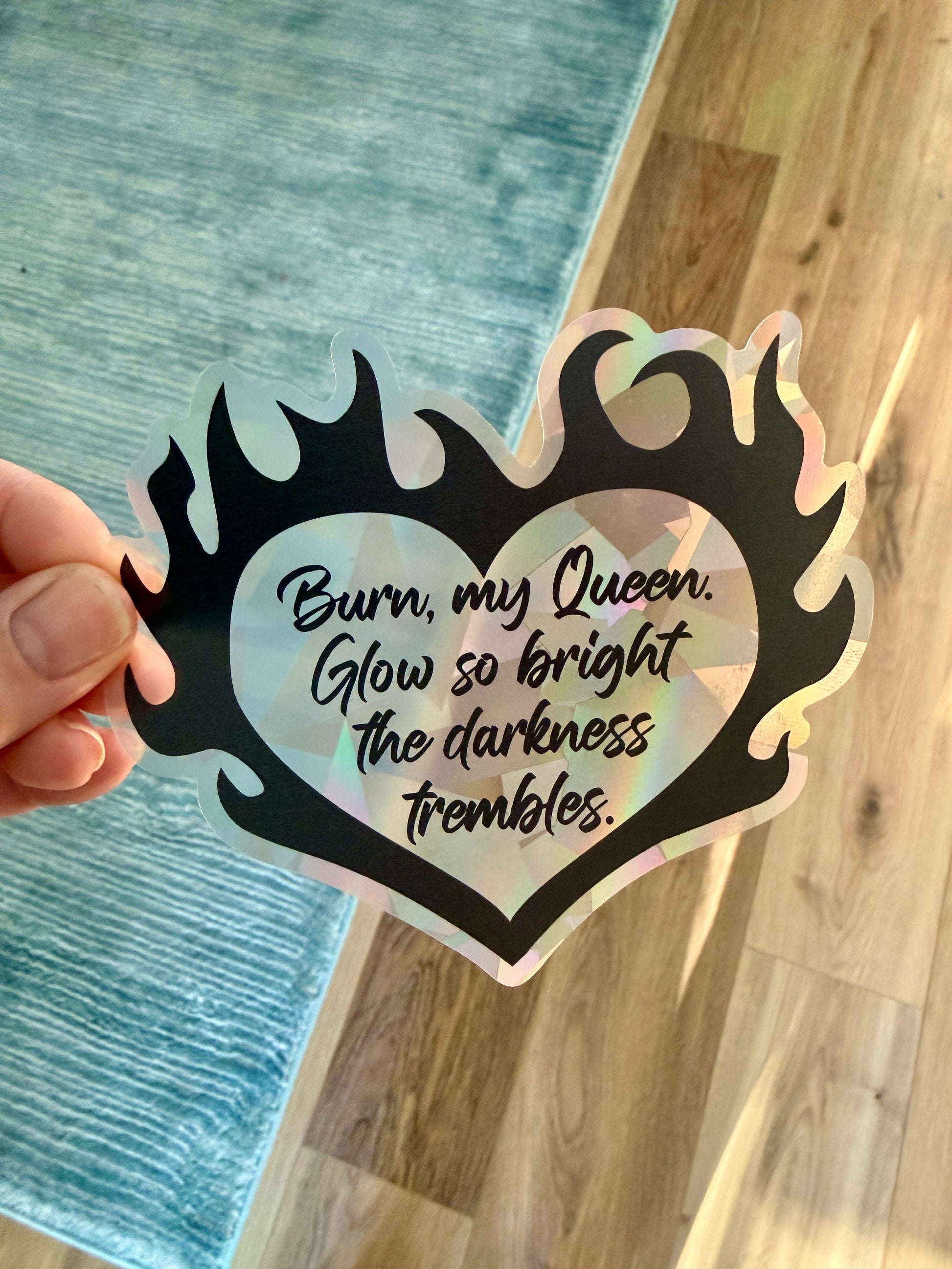 Flaming heart suncatcher decal with the quote "Burn, my Queen. Glow so bright the darkness trembles."