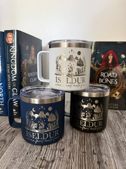 Three insulated travel mugs with 'Iseldur: where frost meets fire' bookish design on a wooden surface, with Demi Winters' The Road of Bones and Kingdom of Claw books in the background.