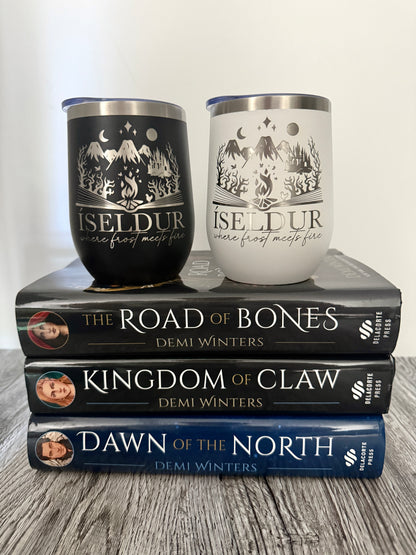 Two wine tumblers with 'Iseldur: where frost meets fire' bookish design on top of three books by Demi Winters: The Road of Bones, Kingdom of Claw and Dawn of the North