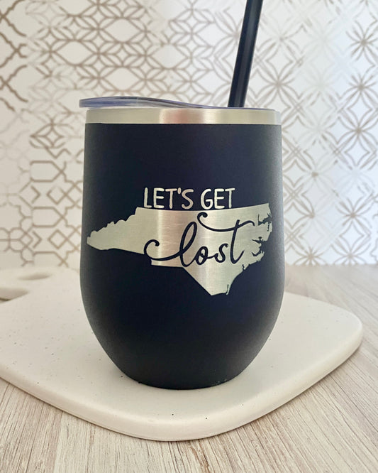 navy blue wine tumbler engraved with NC silhouette and the words let's get lost