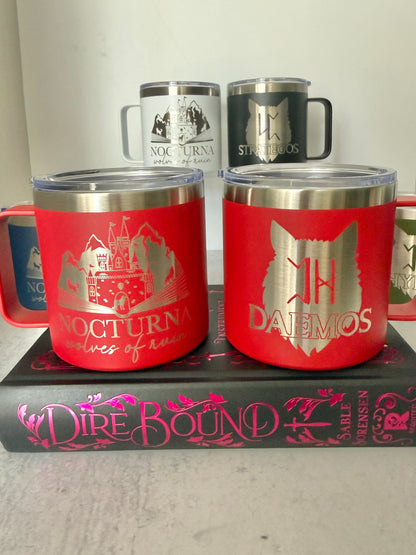 Set of insulated mugs with Nocturna castle and wolf designs on a book titled 'Dire Bound'.