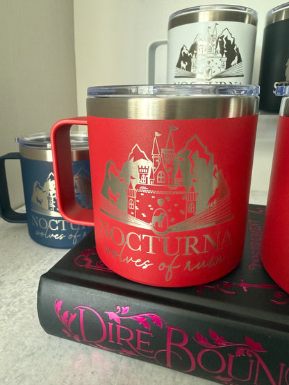 Close-up of a red camp mug with Nocturna wolves of ruin design on a Dire Bound book