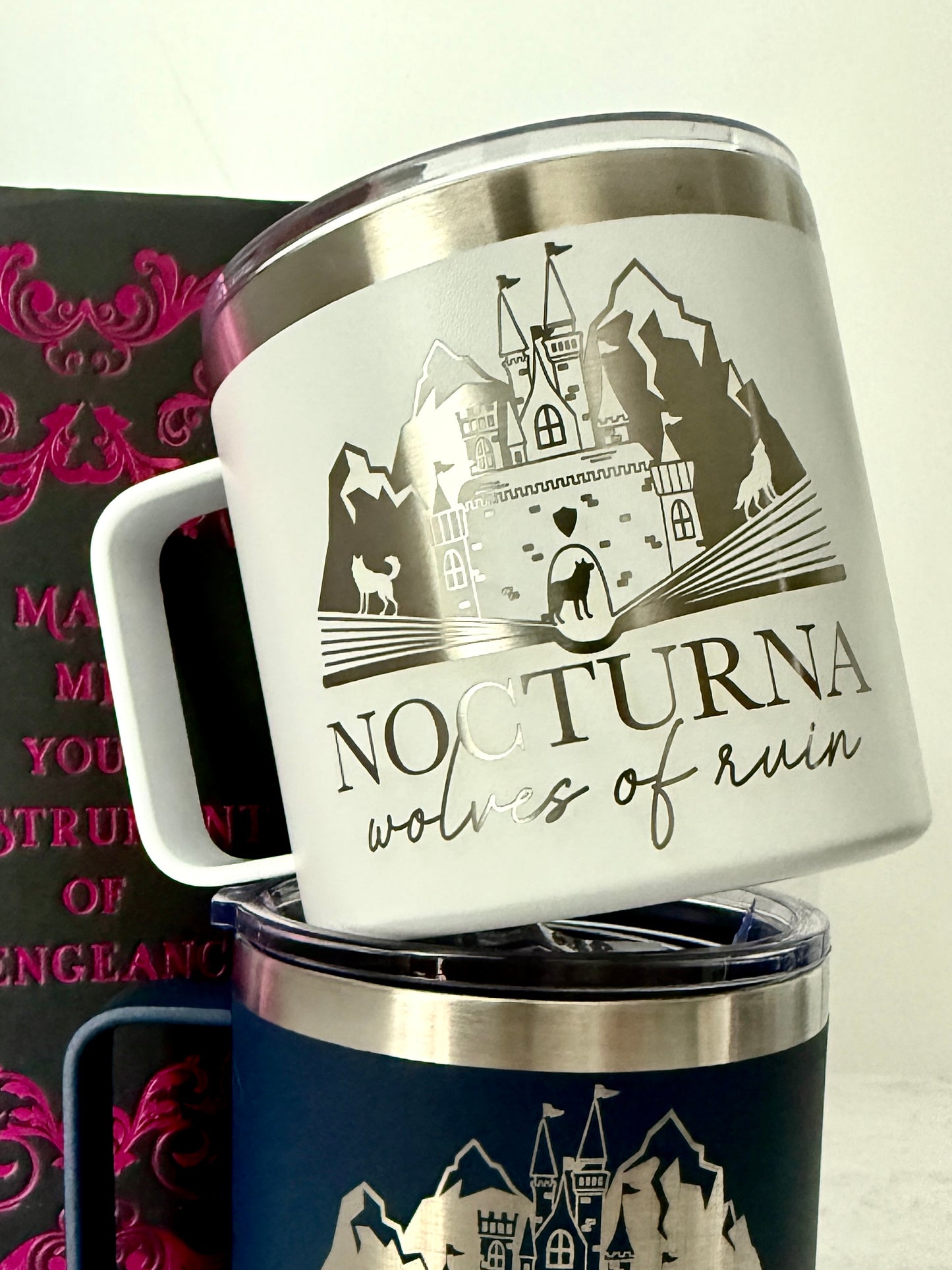 White mug with 'Nocturna wolves of ruin' design and castle illustration, placed on a white background.