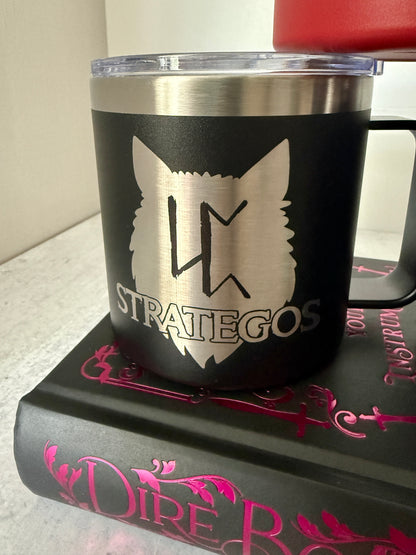 Black mug with a Strategos wolf pack logo on a Dire Bound book