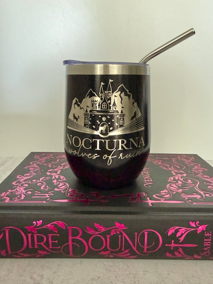 Black tumbler with 'Nocturna' design on a book titled 'Dire Bound'.