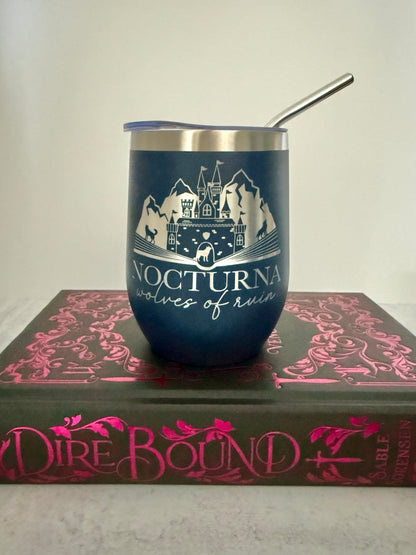 Navy blue tumbler with white design on a book titled 'Dire Bound'.
