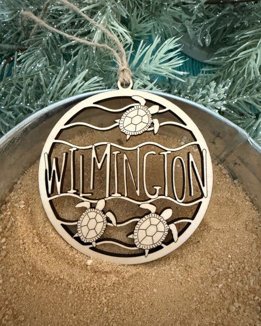 Decorative ornament with 'Wilmington' and turtle designs on a textured surface.