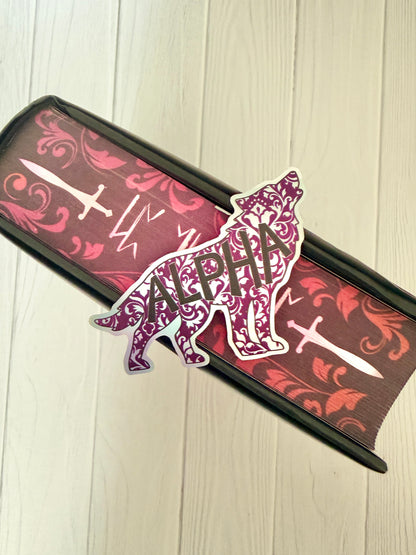 Holographic sticker cut in a wolf design and 'ALPHA' text on the sprayed edges of the Dire Bound book.