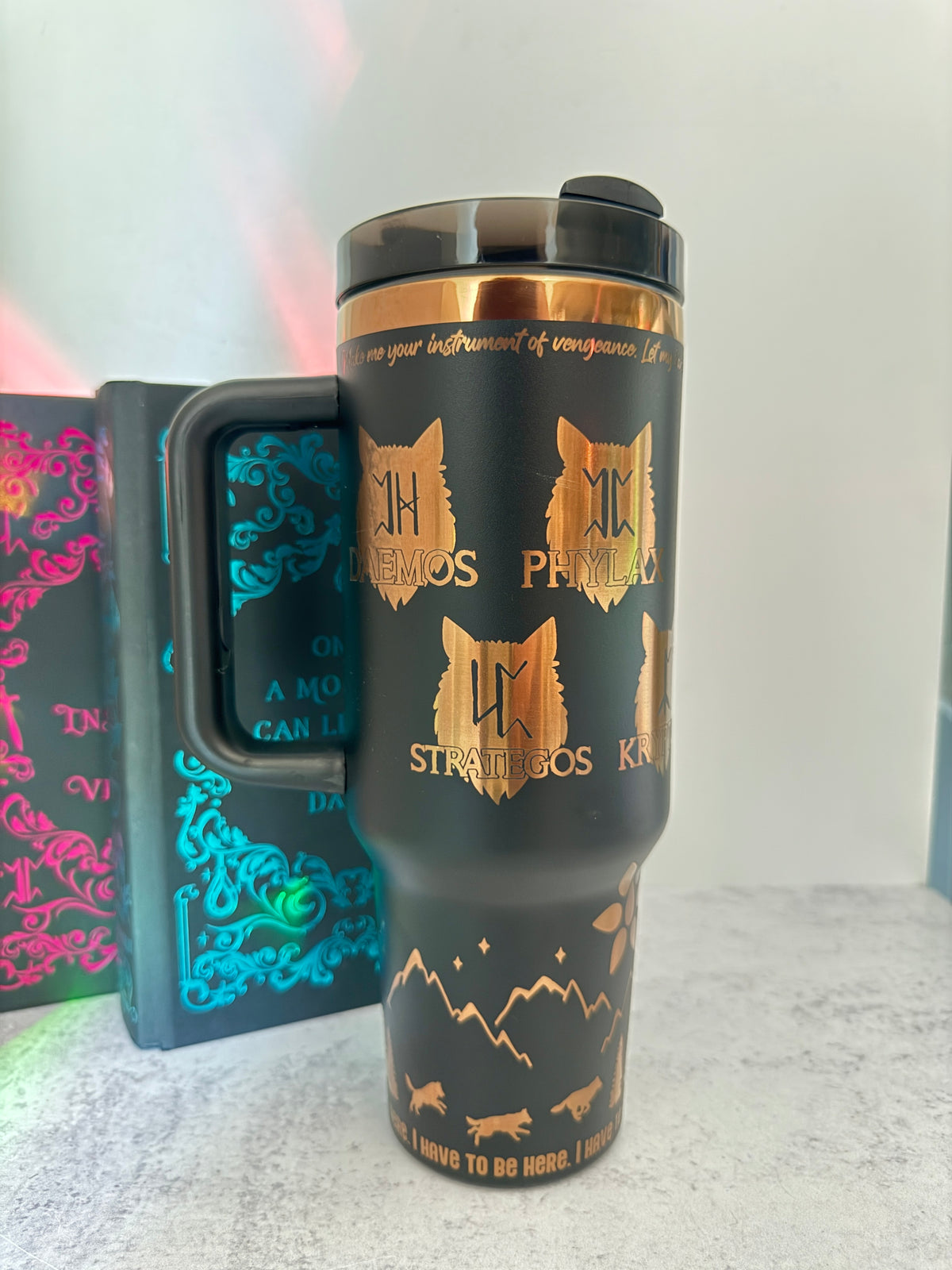 Black 40 oz Dire Bound inspired tumbler with gold-engraved wolf pack symbols for Daemos, Phylax, Strategos and Kryptos