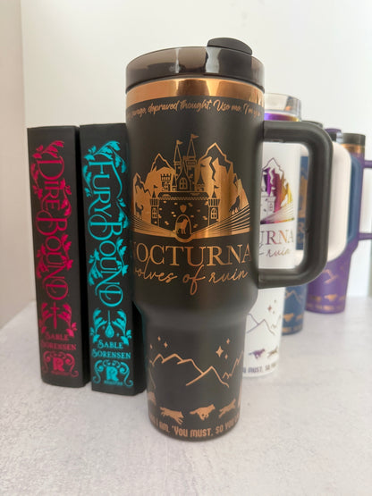 Black 40 oz Dire Bound inspired tumbler with a gold-engraved Nocturna castle, mountains, and wolves