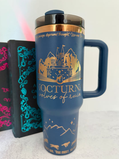 Blue 40 oz Dire Bound inspired tumbler with a gold-engraved Nocturna castle, mountains, and wolves