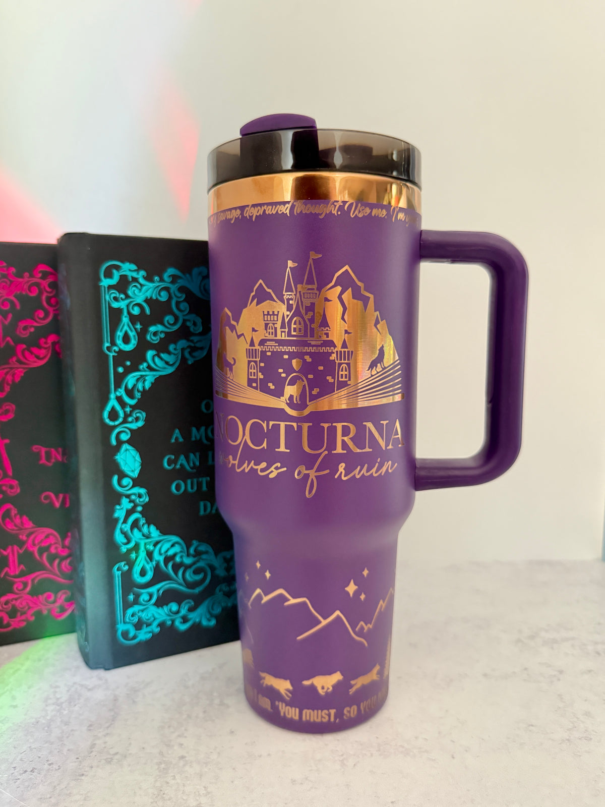 Purple 40 oz Dire Bound inspired tumbler with a gold-engraved Nocturna castle, mountains, and wolves