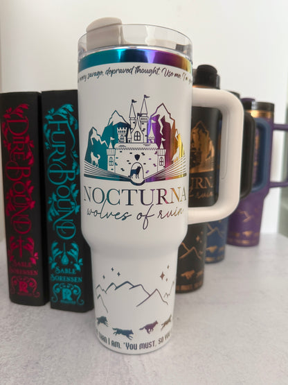 White 40 oz Dire Bound inspired tumbler with a rainbow-engraved Nocturna castle, mountains, and wolves