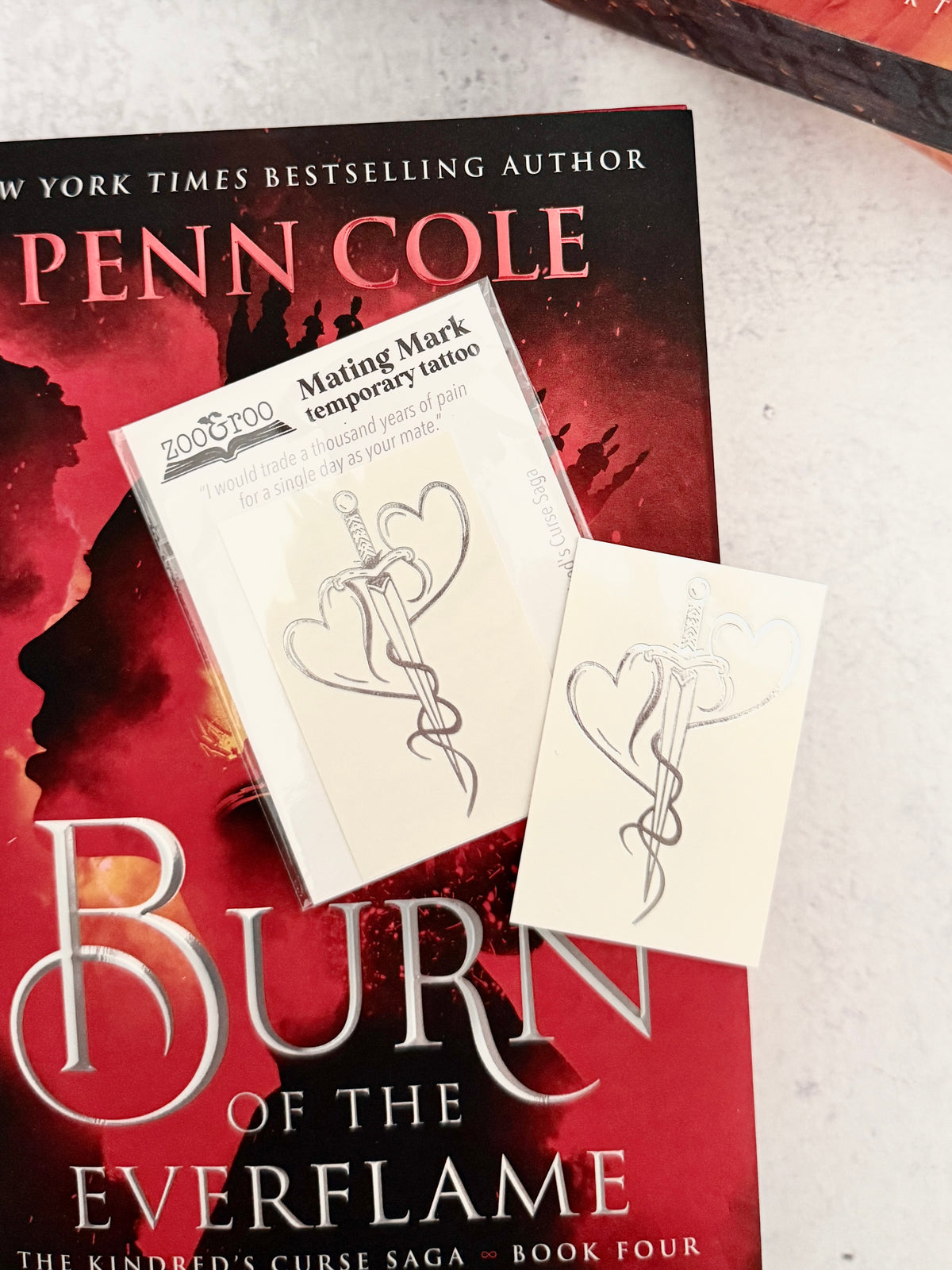 Two hearts forged into a dagger - the mating mark temporary tattoo resting on the cover of Burn of the Everflame by Penn Cole
