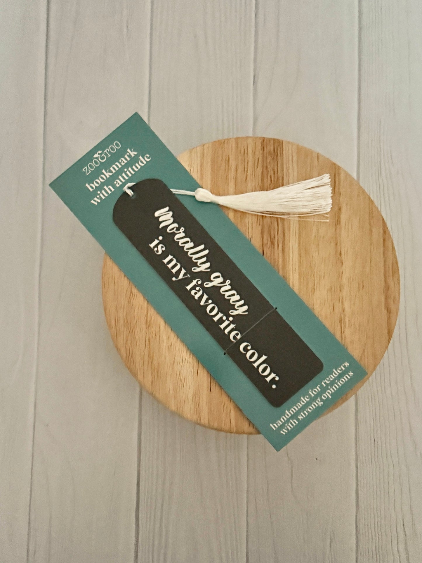 Bookmark with text "morally gray is my favorite color" on a wooden coaster and a card that reads "bookmark with attitude."
