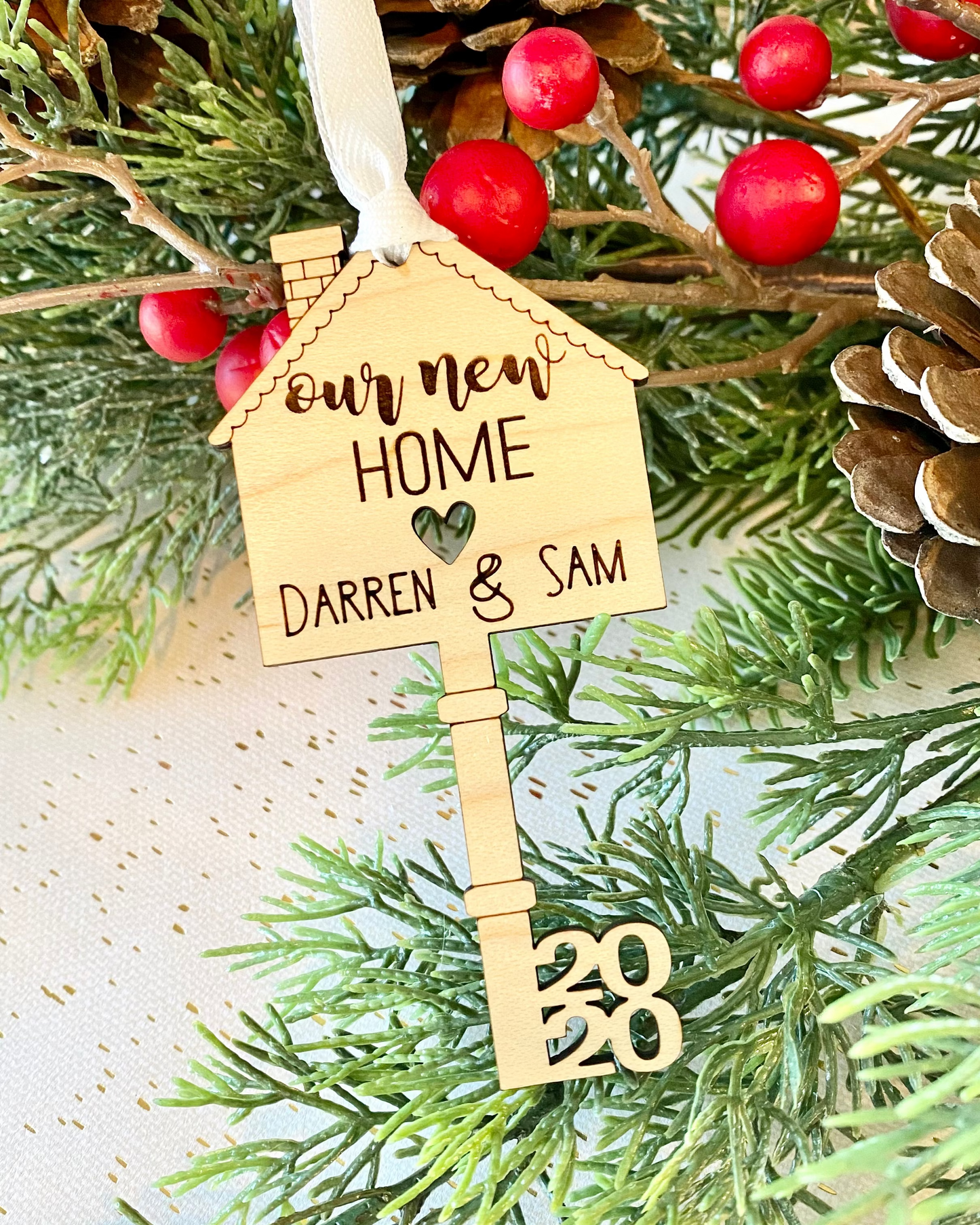 Decorative key ornament with a house on the top and 'our new home' text engraved and personalized with names and year