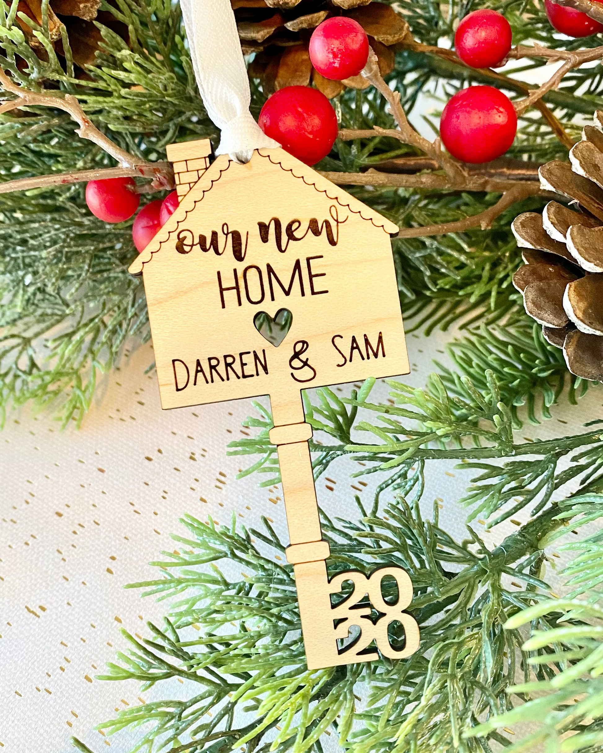 Decorative key ornament with a house on the top and 'our new home' text engraved and personalized with names and year