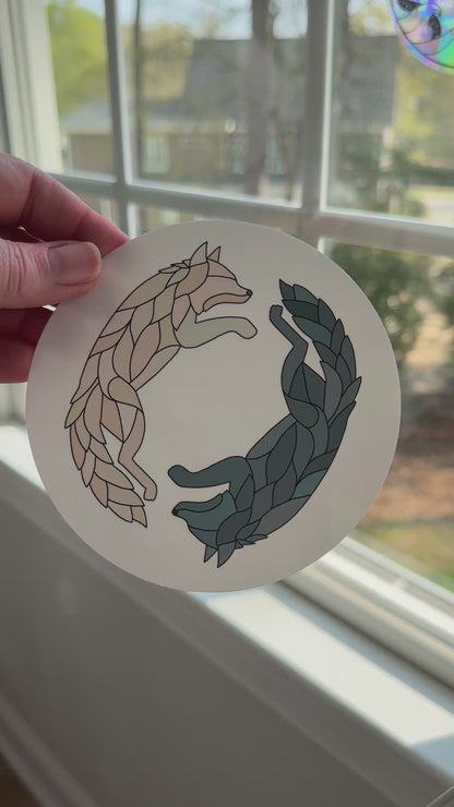 Video of a wolf decal being removed off a white backing to reveal the rainbow holographic colors