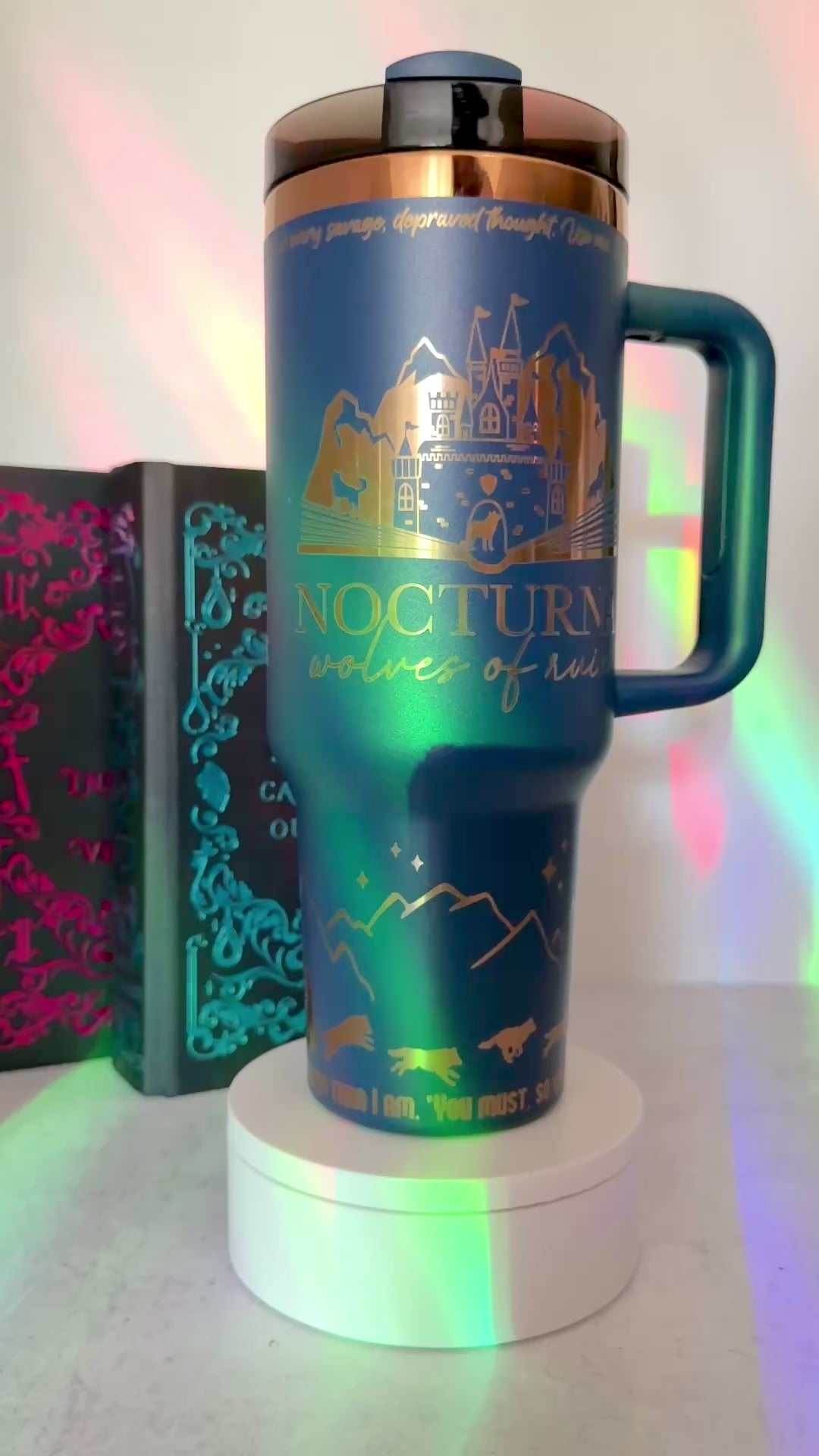 Blue 40 oz Dire Bound inspired tumbler with gold-engraved Nocturna castle, mountains, wolves and wolf pack symbols for Daemos, Strategos, Phylax and Kryptos