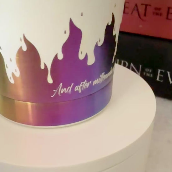 Slow turn of a white and rainbow iridescent 20 oz Emarion tumbler focusing on a quote from Burn of the Everflame by Penn Cole