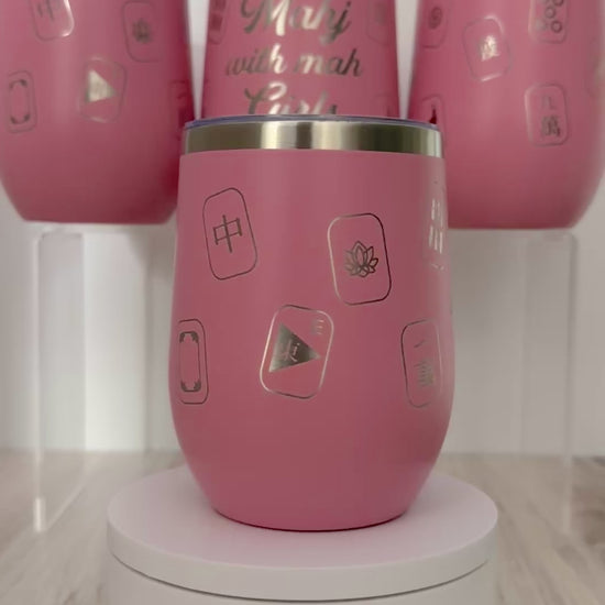 Mahjong wine tumbler with 'mahj with mah girls' text and mahjong tiles wrapped around the pink tumbler.