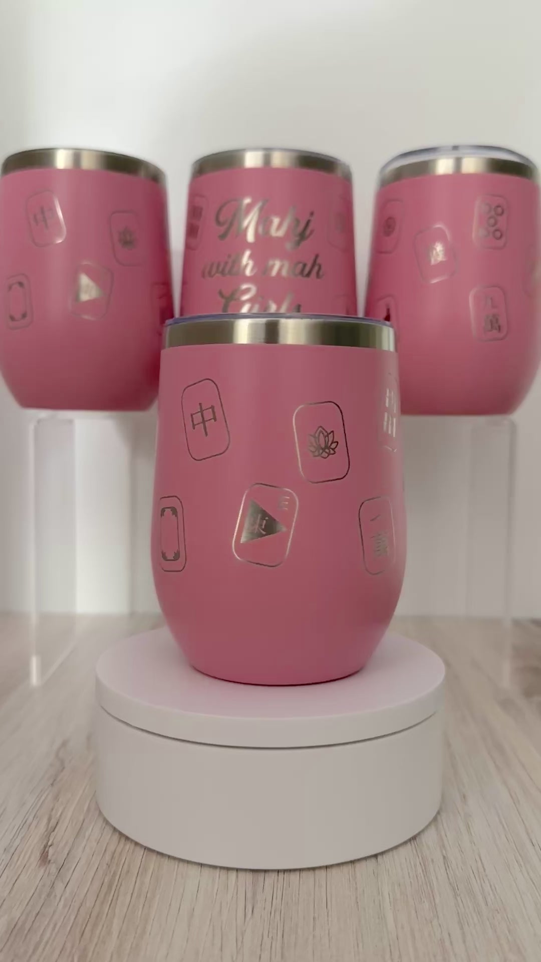 Mahjong wine tumbler with 'mahj with mah girls' text and mahjong tiles wrapped around the pink tumbler.