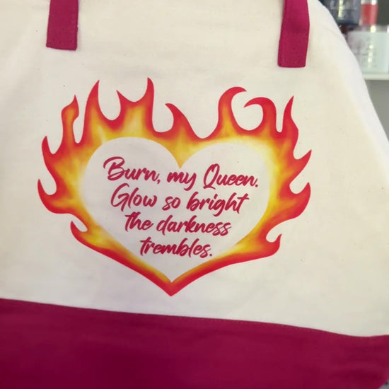 Tote bag inspired by The Kindred's Curse Saga by Penn Cole with a flaming heart design and quote "Burn my Queen. Glow so bright the darkness trembles" on one side and an original Emarion design with "rise from the ashes" on the other.