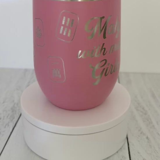 Mahjong wine tumbler with 'mahj with mah girls' text and mahjong tiles wrapped around the pink tumbler.