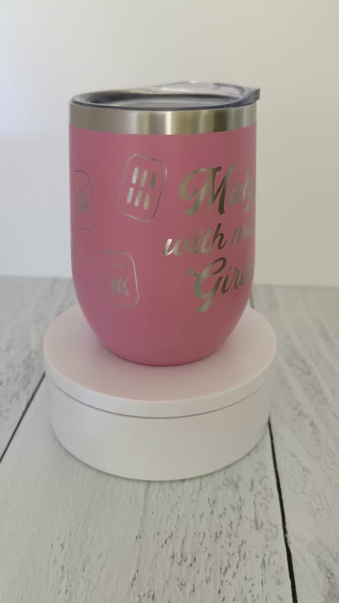 Mahjong wine tumbler with 'mahj with mah girls' text and mahjong tiles wrapped around the pink tumbler.