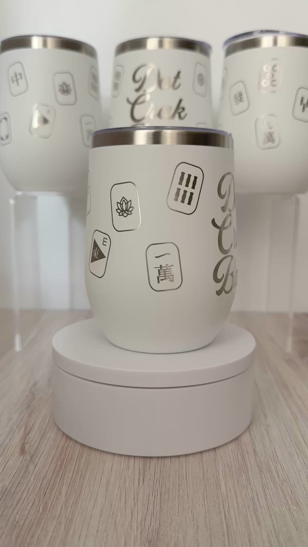Mahjong wine tumbler with 'dot crak bam' text and mahjong tiles wrapped around the white tumbler.