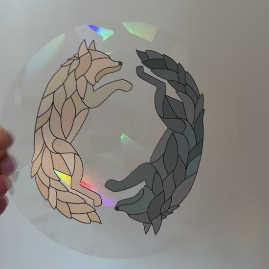 Video of a holographic wolf suncatcher decal sticker inspired by Dire Bound