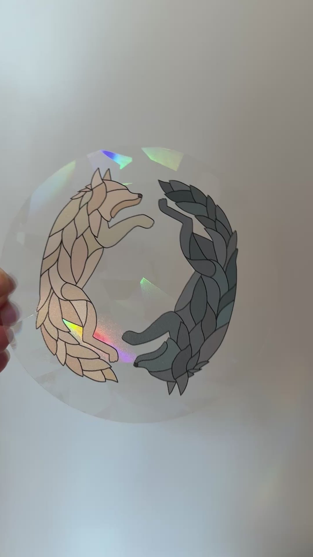Video of a holographic wolf suncatcher decal sticker inspired by Dire Bound