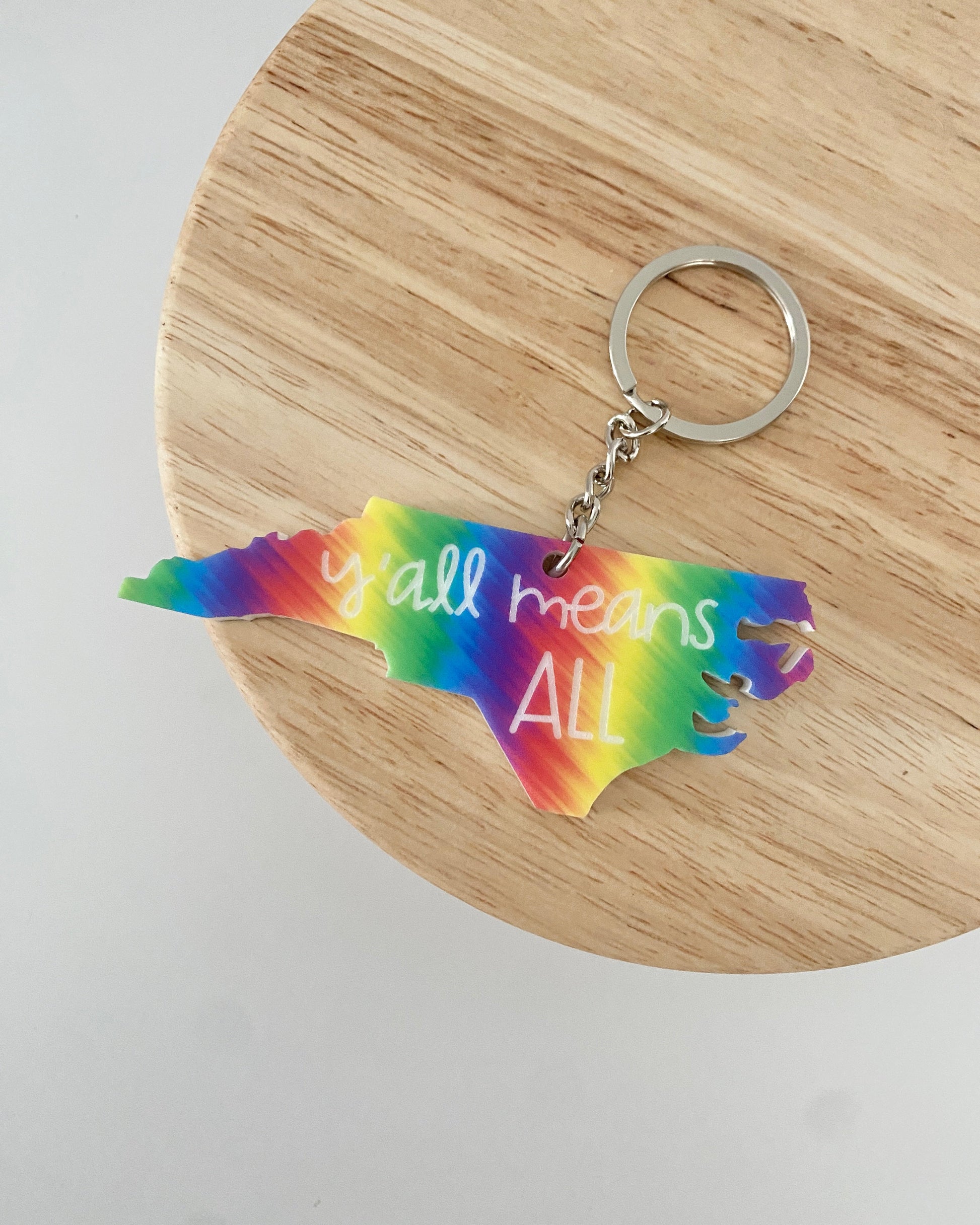 rainbow keychain engraved with "y'all means all"